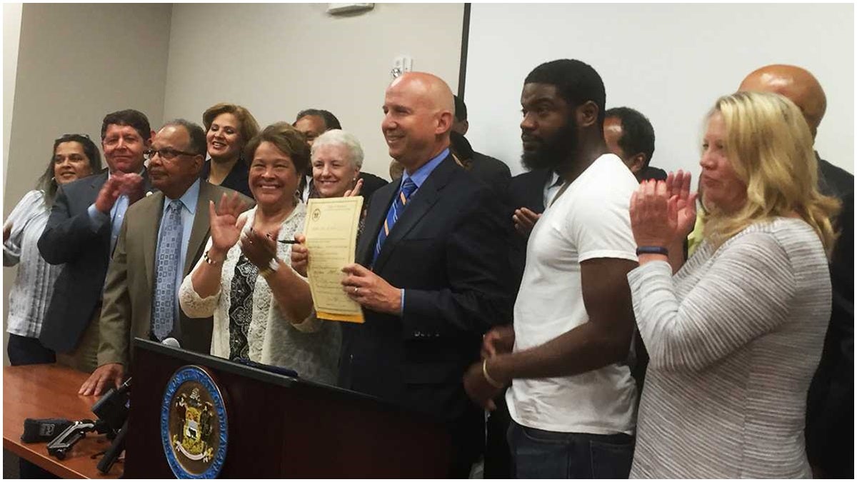 Governor Markell is joined by lawmakers and supporters after signing the law allowing ex-offenders more voting rights. (File/WHYY)