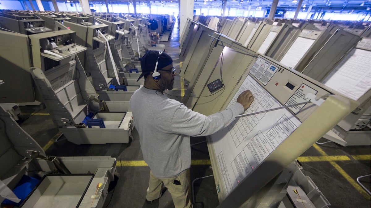 A technician works to prepare voting machines to be used in the upcoming presidential election