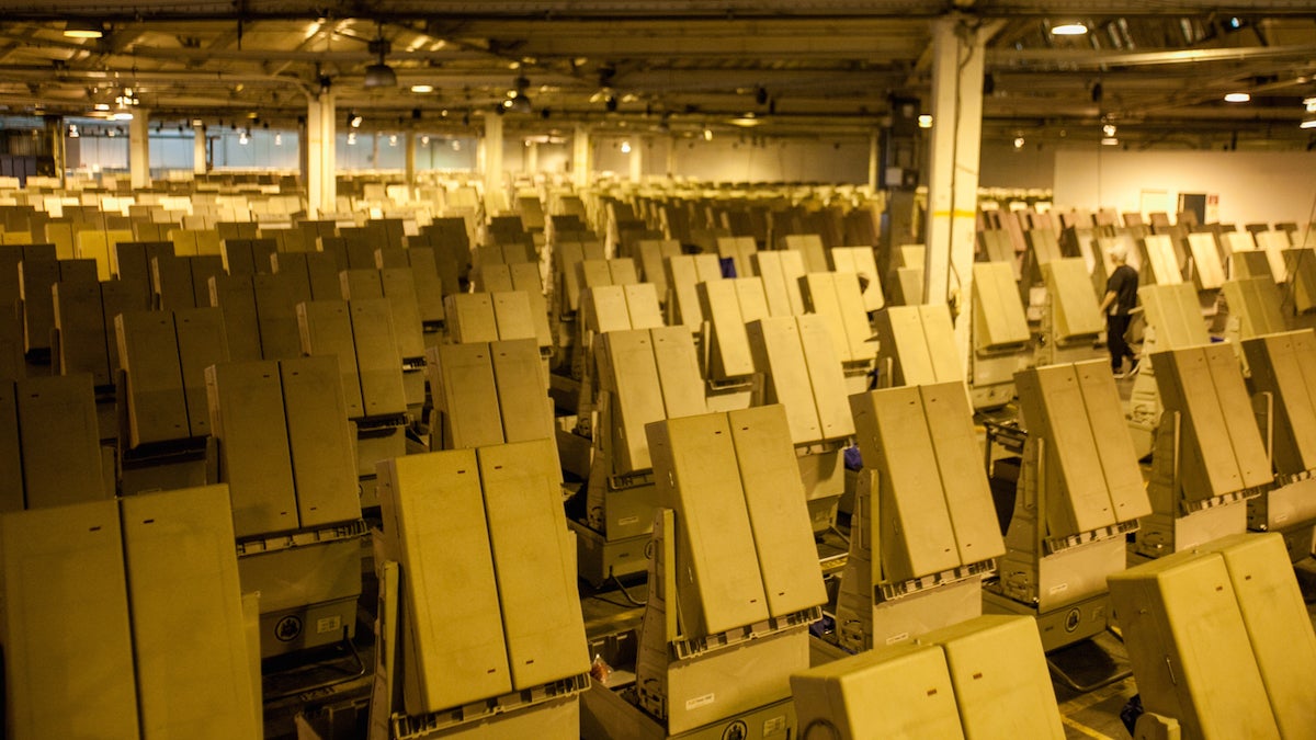 Workers prepare voting machines at the Office of the  City Commissioner's warehouse the day before the recount of votes in 75 precincts was set to begin. (Brad Larrison for WHYY)