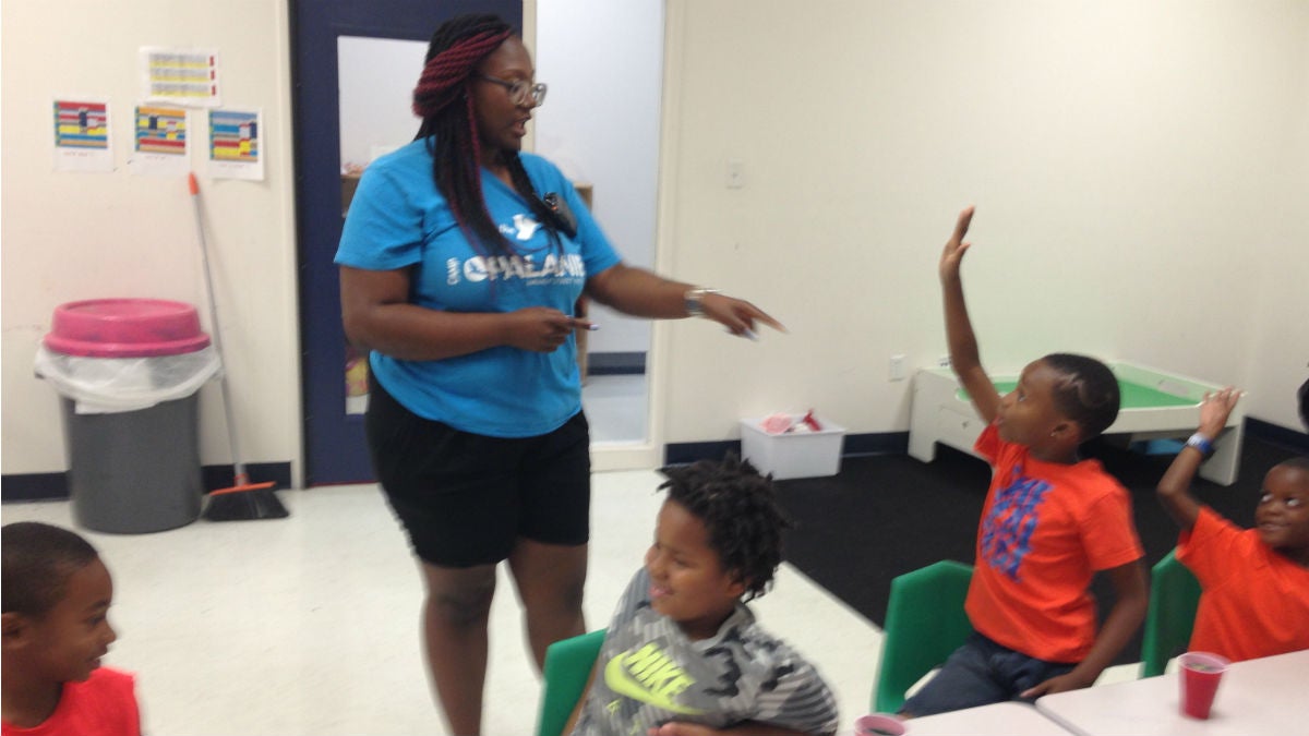  A counselor with students at the Walnut Street YMCA summer camp. (Avi Wolfman-Arent, NewsWorks) 