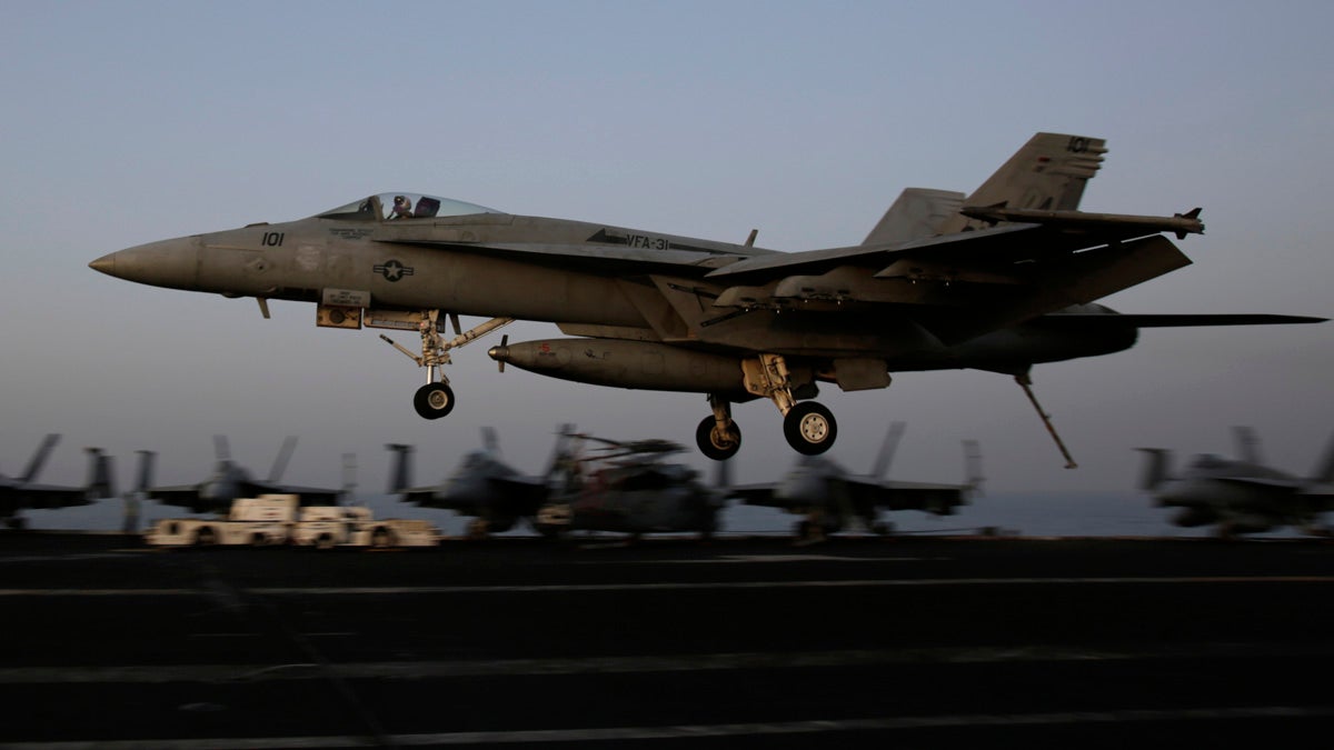  An F/A-18C Hornet coming from Iraq lands on the flight deck of the U.S. Navy aircraft carrier USS George H.W. Bush, Sunday, Aug. 10, 2014, in the Persian Gulf. Aircraft aboard the George H.W. Bush are flying missions over Iraq after U.S. President Barack Obama authorized airstrikes against Islamic militants and food drops for Iraqis trapped by the fighters. (AP Photo/Hasan Jamali) 