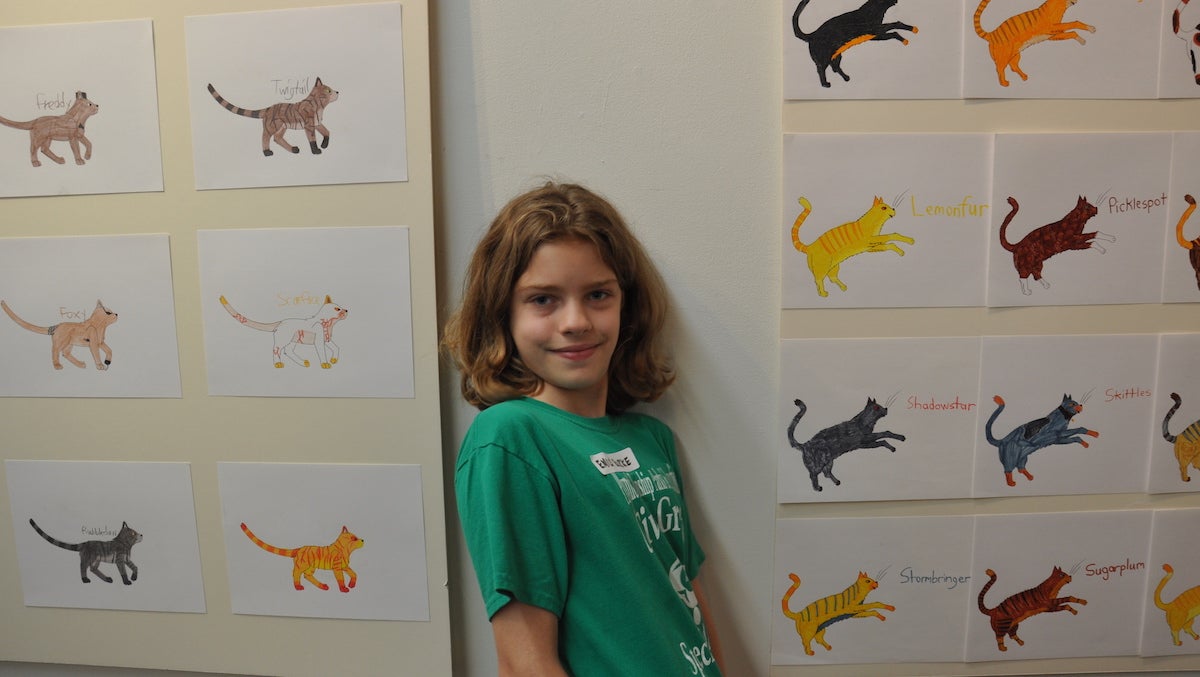  Emily Burke with her drawings. (Greta Iverson/for NewsWorks) 