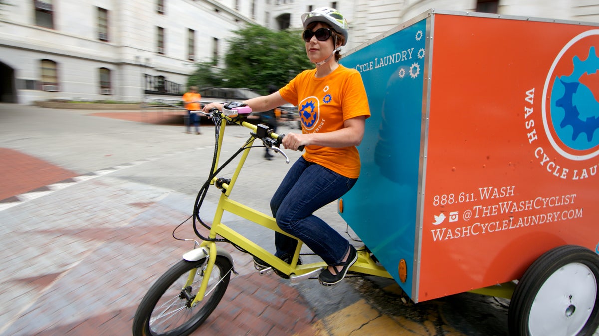  Andrea Adleman rides one of Wash Cycle Laundry's special delivery trikes. The company is expanding to Washington, D.C., its second market. (Nathaniel Hamilton/for NewsWorks) 