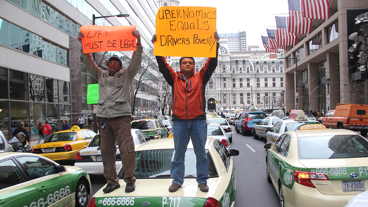  Philadelphia cab drivers block Market Street Wednesday in protest against illegal rideshares. (Emma Lee/WHYY) 