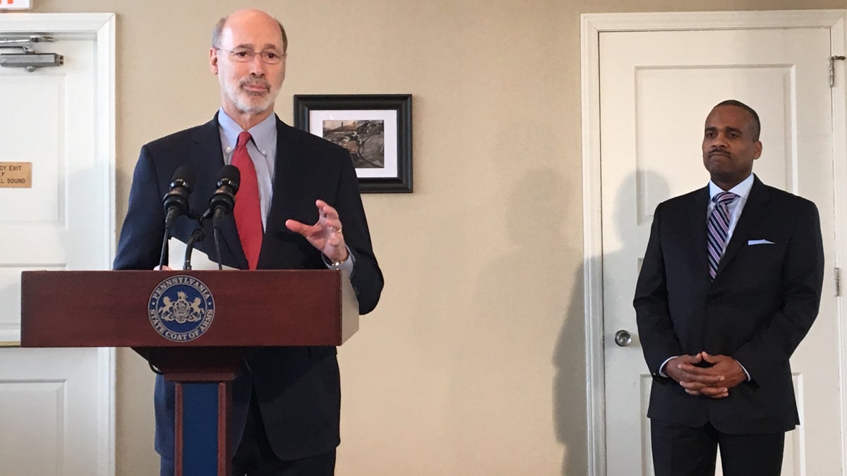 Pennsylvania Gov. Tom Wolf announces the fund consolidation at a press conference alongside Timothy Reese