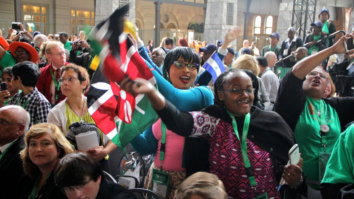  Myriam Mwangi (center) and Katherine Gachanja of Nairobi, Kenya, celebrate as the World Meeting of Families officially opens in the Grand Ballroom of the Pennsylvania Convention Center. (Emma Lee/WHYY) 