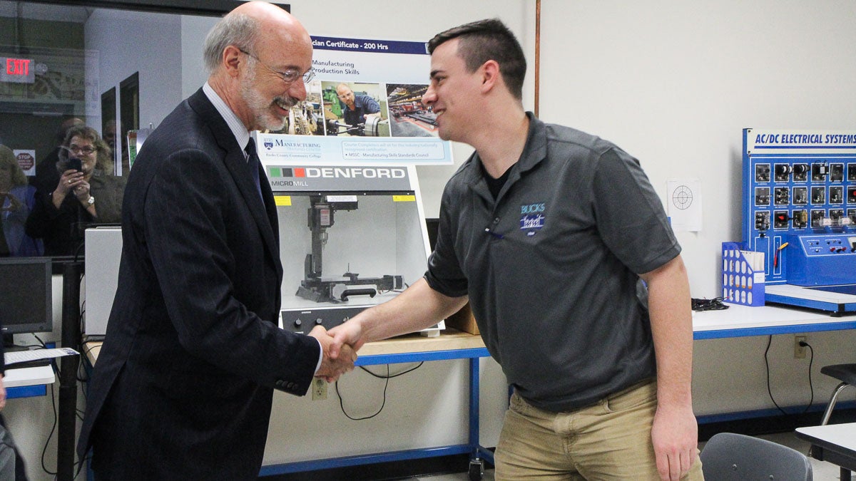 Governor Tom Wolf meets Advanced Manufacturing Training Center at Bucks County Community College student Nick Mastrobattista. (Kimberly Paynter/WHYY)