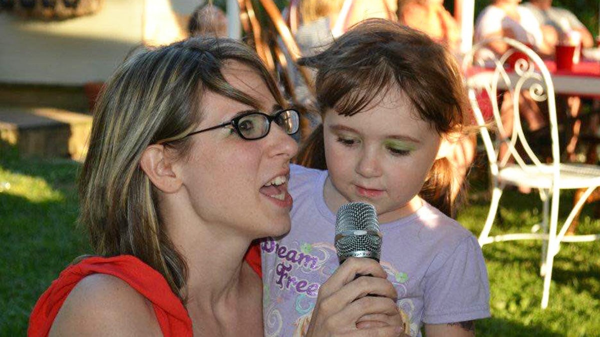 Amy Day speaks at an event with her daughter by her side. (Courtesy of Cheri Collins)