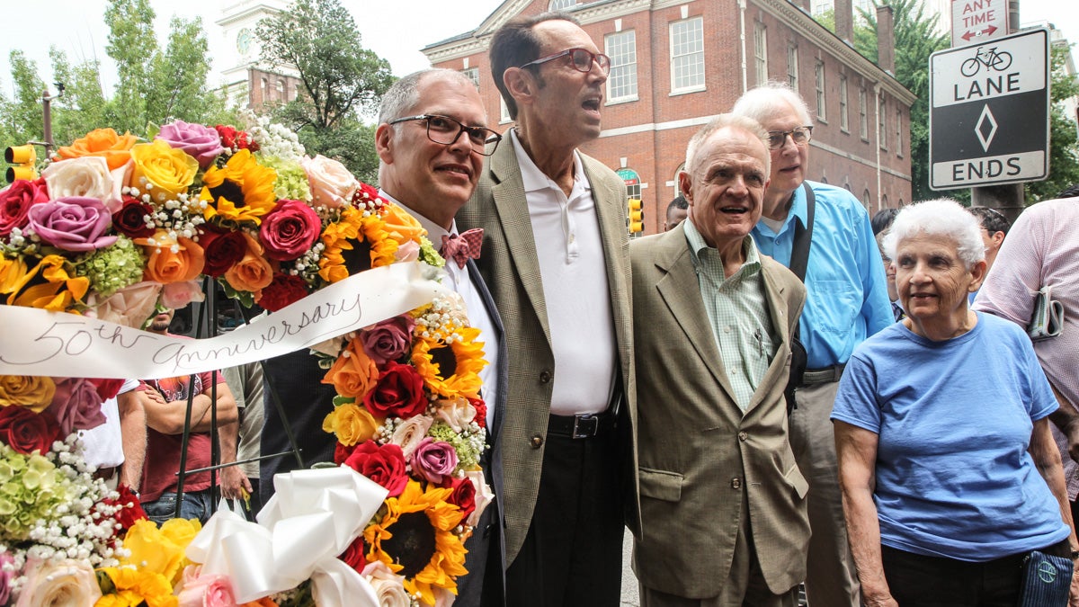  Jim Obergefell, Malcolm Lazin, Paul Kuntzler and Ada Bello place a wreath in front of a Philadelphia plaque honoring LBGT pioneers. (Kimberly Paynter/WHYY) 