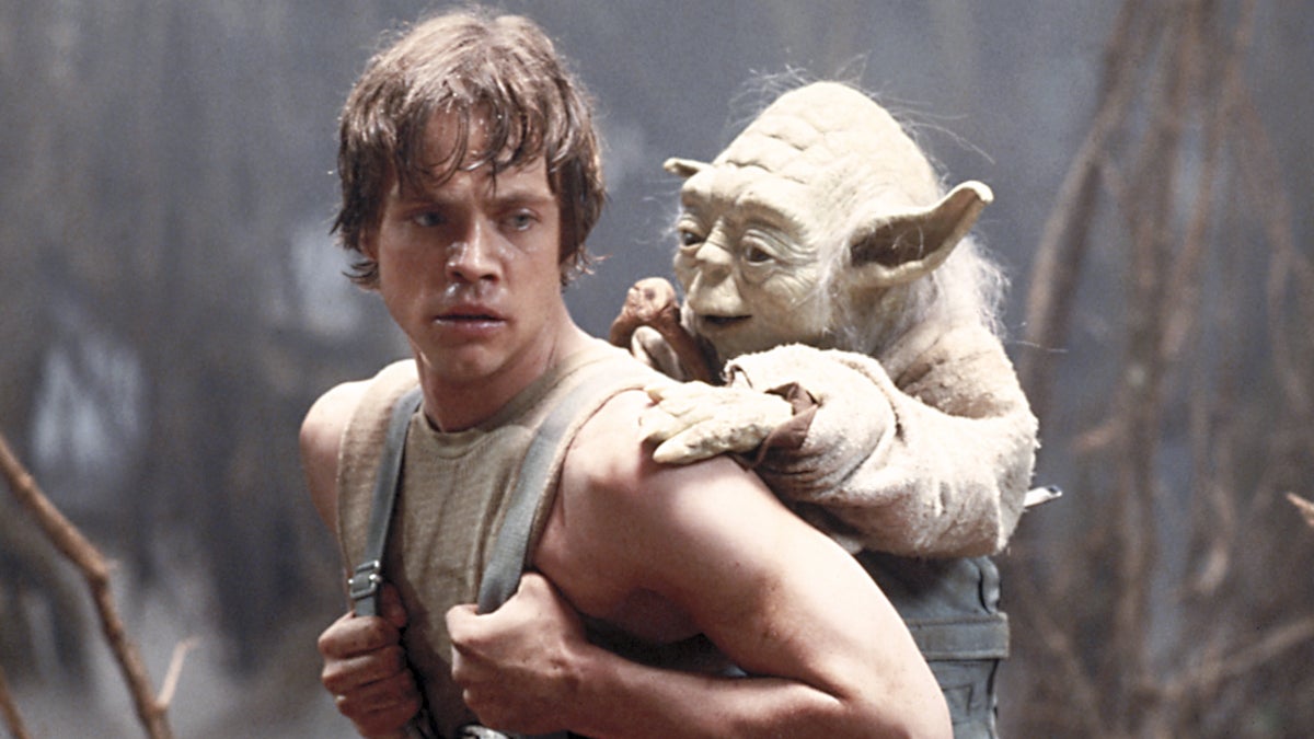  Mark Hamill as Luke Skywalker and the character Yoda appear in this scene from 