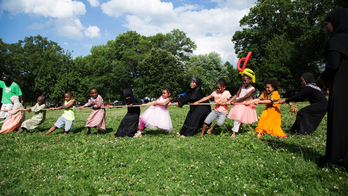 Children play a game of tug of war at Eid al-Fitr festivities in FDR Park in South Philadelphia, Sunday, June 25, 2017. (Annie Risemberg for NewsWorks)