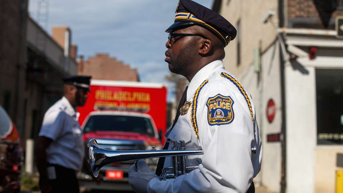 Philadelphia Police Officer Ron Baker stands with his bugle before marching to the Betsy Ross House for a ceremony honoring first responders on the 15th anniversary of the September 11th terror attacks.