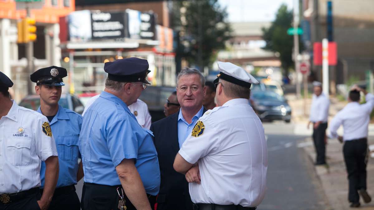 Mayor Jim Kenney chats with Philadelphia Firefighters before marching to the Betsy Ross House for a ceremony honoring first responders on the 15th anniversary of the September 11th terror attacks.