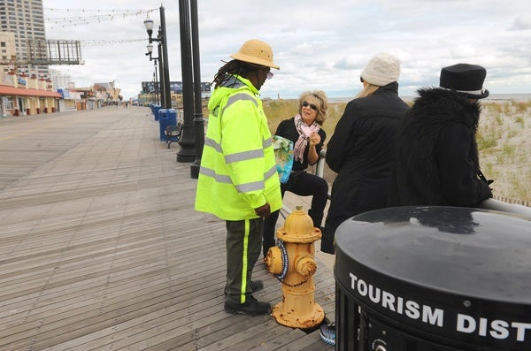 <p><p>Ambassador Dwight King with the Casino Reinvestment Development Authority talks with people out on the Boardwalk. The Boardwalk in front of the casinos was not damaged by the storm. (Photography by Peter Tobia/Atlantic City Alliance)</p></p>
