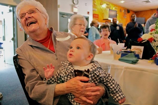 <p><p>Joan White, widow of firefighter Ed White, laughs while she holds her grandson, Myan McGill at the annual Thanksgiving luncheon for widows. (Emma Lee/for NewsWorks)</p></p>

