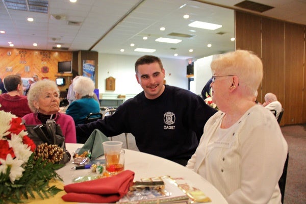 <p><p>John Udovich, a volunteer from the firefighters academy, waits on widows Vivian Jordan (left) and Marie Bonner at the annual Thanksgiving luncheon for widows of fallen firefighters. (Emma Lee/for NewsWorks)</p></p>
