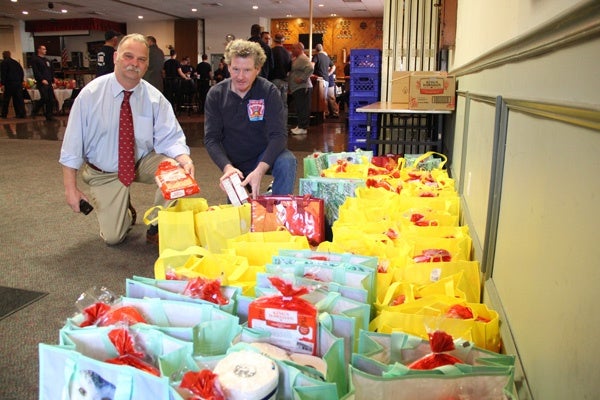 <p><p>Philadelphia Firefighters Local 22 President Bill Gault and Joseph Tracy load up some of the 120 Thanksgiving meals that will be delivered by firefighters. (Emma Lee/for NewsWorks)</p></p>

