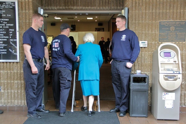<p><p>Firefighter academy cadets escort Eva Foley, widow of Frank Foley, into the banquet hall of Fire Fighters Local 22 for the annual widows' Thanksgiving luncheon. (Emma Lee/for NewsWorks)</p></p>

