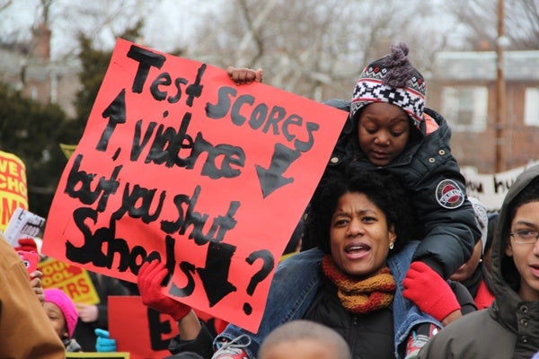 <p><p>With her 5-year-old son Aiden on her shoulders, Lee Jones, vice president of Gompers Home and School, marches to protest the proposed closure of her son's school. (Emma Lee/for NewsWorks)</p></p>
