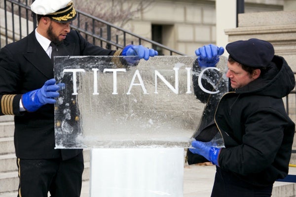 <p><p>Rob Capone and Don Harrison installing the Titanic sign in front of the Franklin Institute. (Nathaniel Hamilton/for NewsWorks)</p></p>
