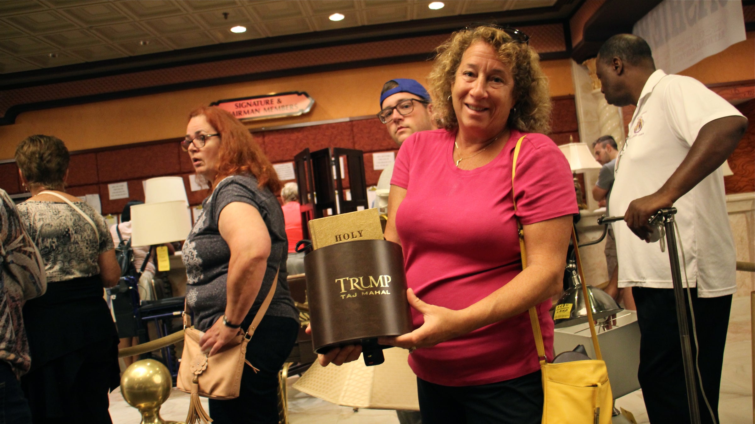 Carolyn Ganzelli of Downingtown, Pennsylvania, shows off a coveted find, an ice bucket with the Trump logo. Items bearing the Trump name were scarce. (Emma Lee/WHYY)