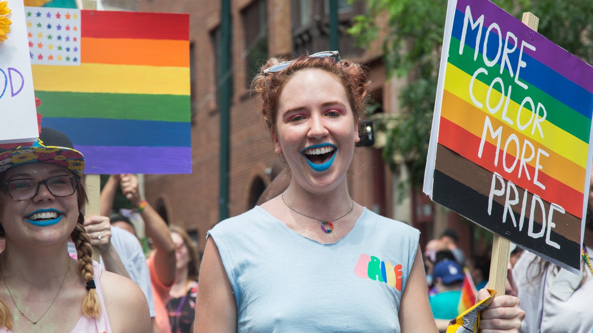 A marcher uses the newly adopted, Philly-introduced pride flag the 2017 Philadelphia Pride Parade, Sunday, June 18, 2017. (Emily Cohen for NewsWorks)