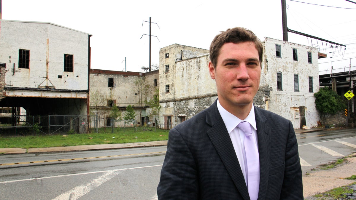 Downingtown Mayor Josh Maxwell stands in front of the Sonoco paper mill on Brandywine Avenue. The abandoned mill brought national attention to the town when it was featured in a Donald Trump tweet. (Emma Lee/WHYY)