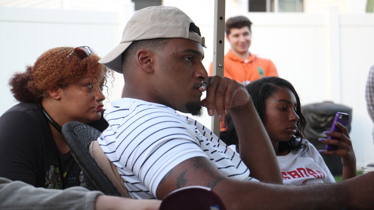 NFL prospect Julién Davenport watches the draft with family and friends on a big-screen in his father's backyard in Blackwood, New Jersey. (Emma Lee/WHYY