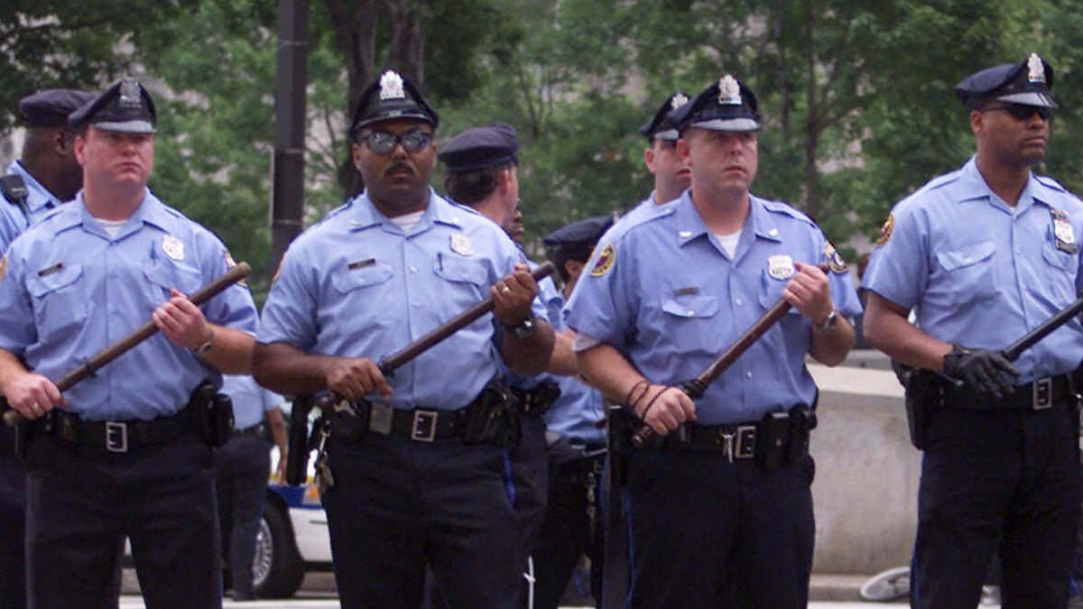  Philadelphia police are shown facing protesters outside of City Hall on the opening day of the 2000 Republican National Convention. (AP Photo/Rick Bowmer) 