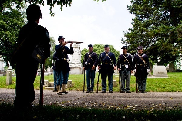 <p><p>44. Matt Piette, of the 71st Pennsylvania Infantry Volunteers, inspects his musket before beginning the traditional Decoration Day service of the Grand Army Meade Post #1 at Laurel Hill Cemetery in East Falls. (Brad Larrison/for NewsWorks)</p></p>
