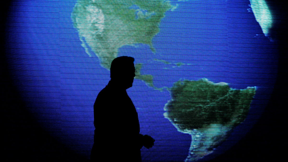  Al Gore is silhouetted against an image of the earth during his talk about climate change in Manila, Philippines. (AP File Photo/Aaron Favila) 