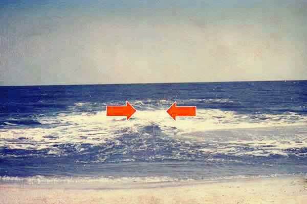  In this NOAA photo, the rip current is surging seaward in the area between the red arrows.  
