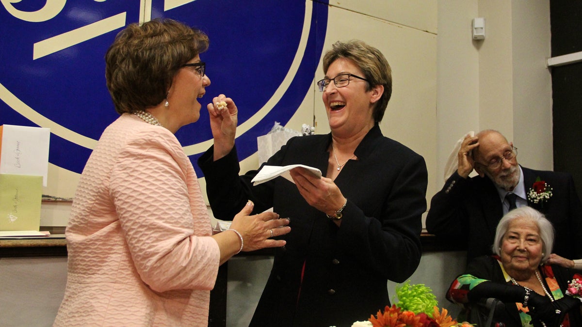  Joanne Schailey feeds cake to Beth Asaro during their wedding reception at the Phillip L. Pittore Justice Center in Lambertville, N.J.  (Emma Lee/for NewsWorks) 