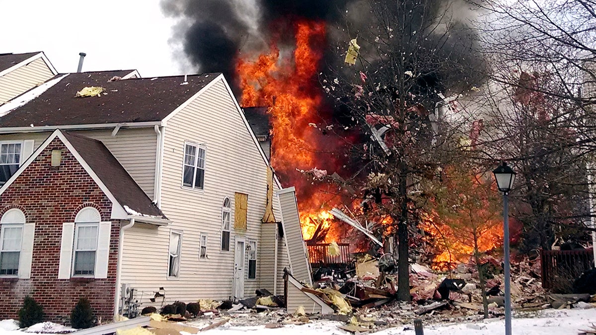  In this image provided by Josh Forst, flames and smoke shoot up after an explosion at a townhouse complex Tuesday.  (AP Photo/Josh Forst) 