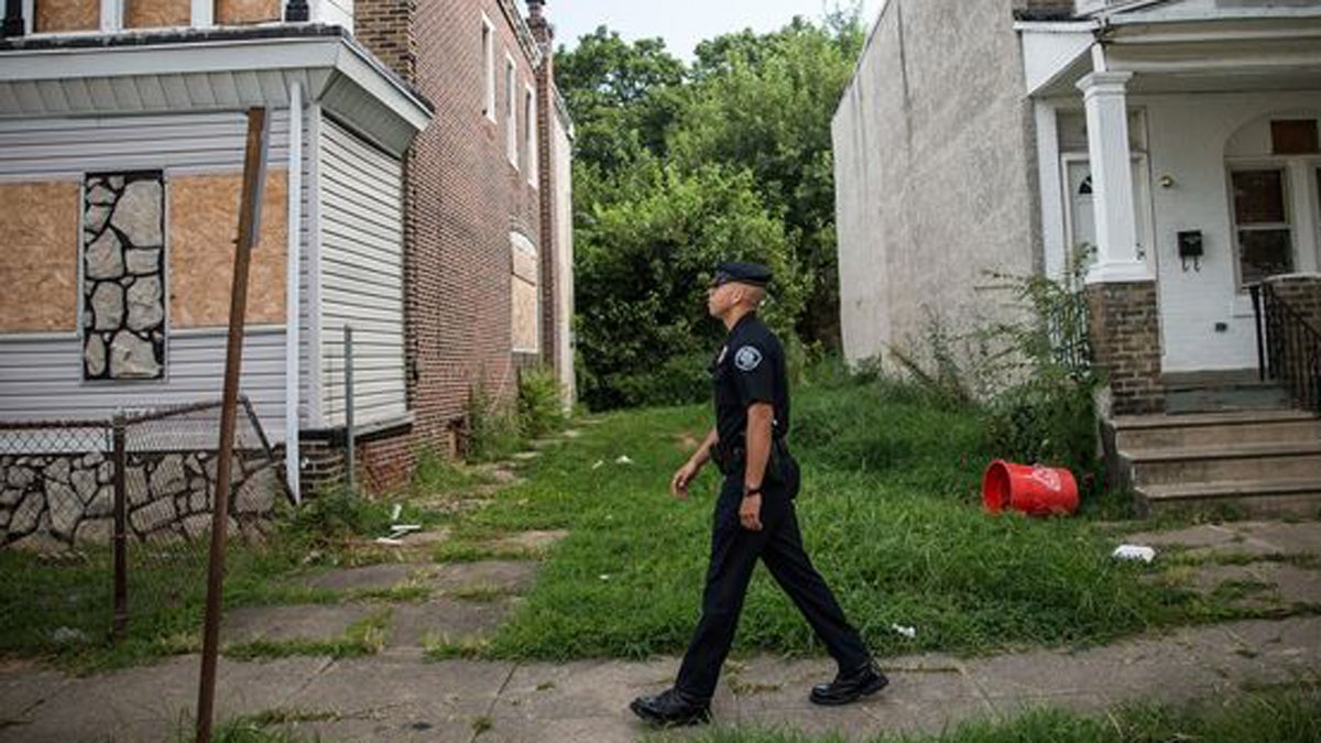 Officer Adam Fulmore, of the Camden County Police Department, goes on a foot patrol on August 22, 2013. (Andrew Burton/Getty 