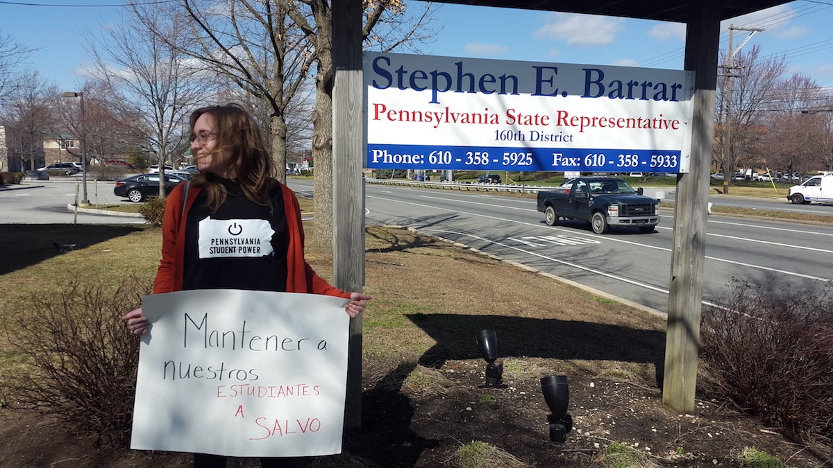  Widener University freshman Hannah Guth protests Pa. House Bill 14 outside of state representative Stephen Barrar's office in Chadd's Ford. (Laura Benshoff/WHYY) 