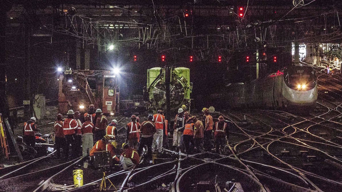  In this Wednesday, April 5, 2017 photo provided by Amtrak, workers repair rails inside New York's Penn Station. (Chuck Gomez/Amtrak via AP) 