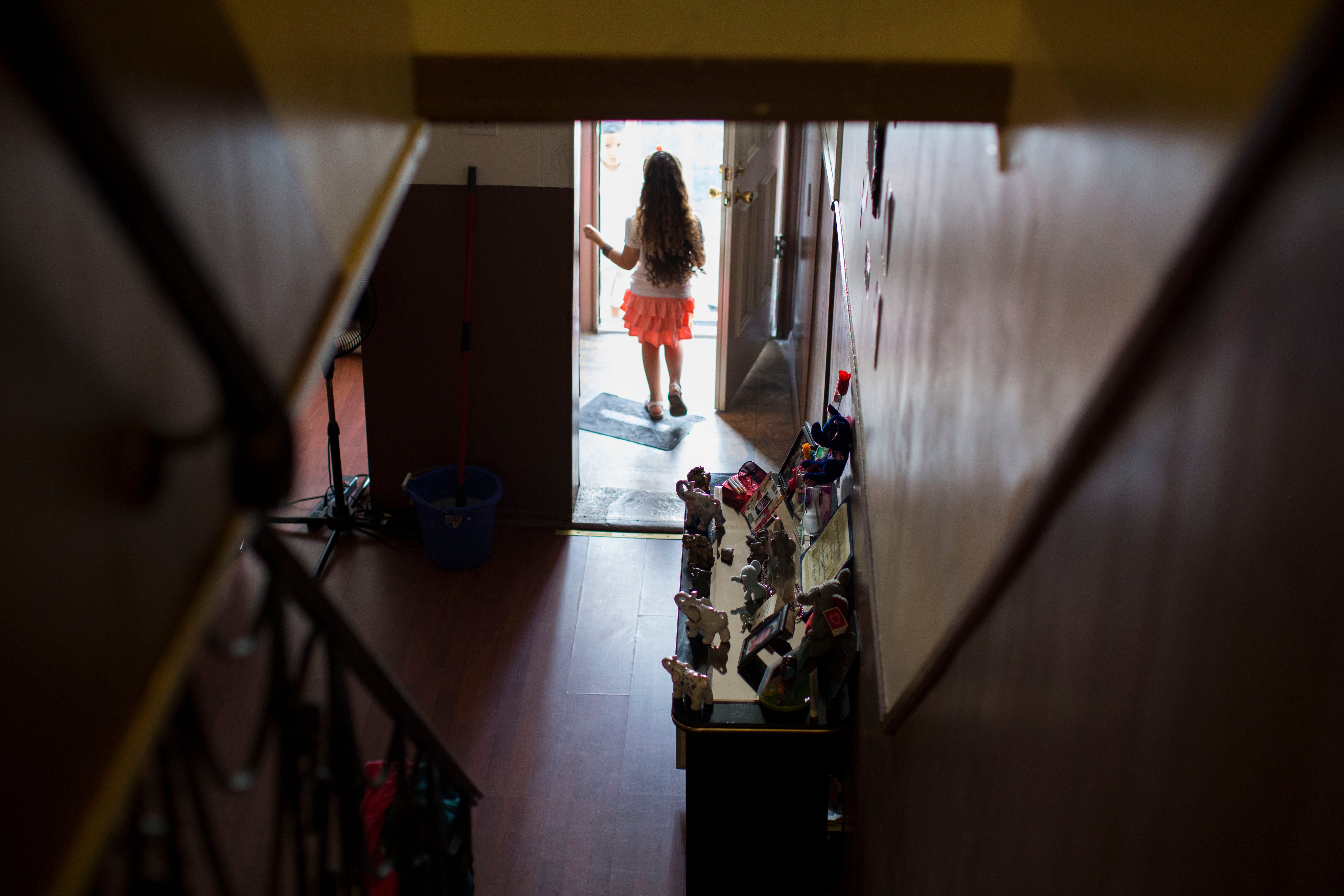 Layla Zayas stands at the front door of her home in Kensington. (Jessica Kourkounis/For Keystone Crossroads)