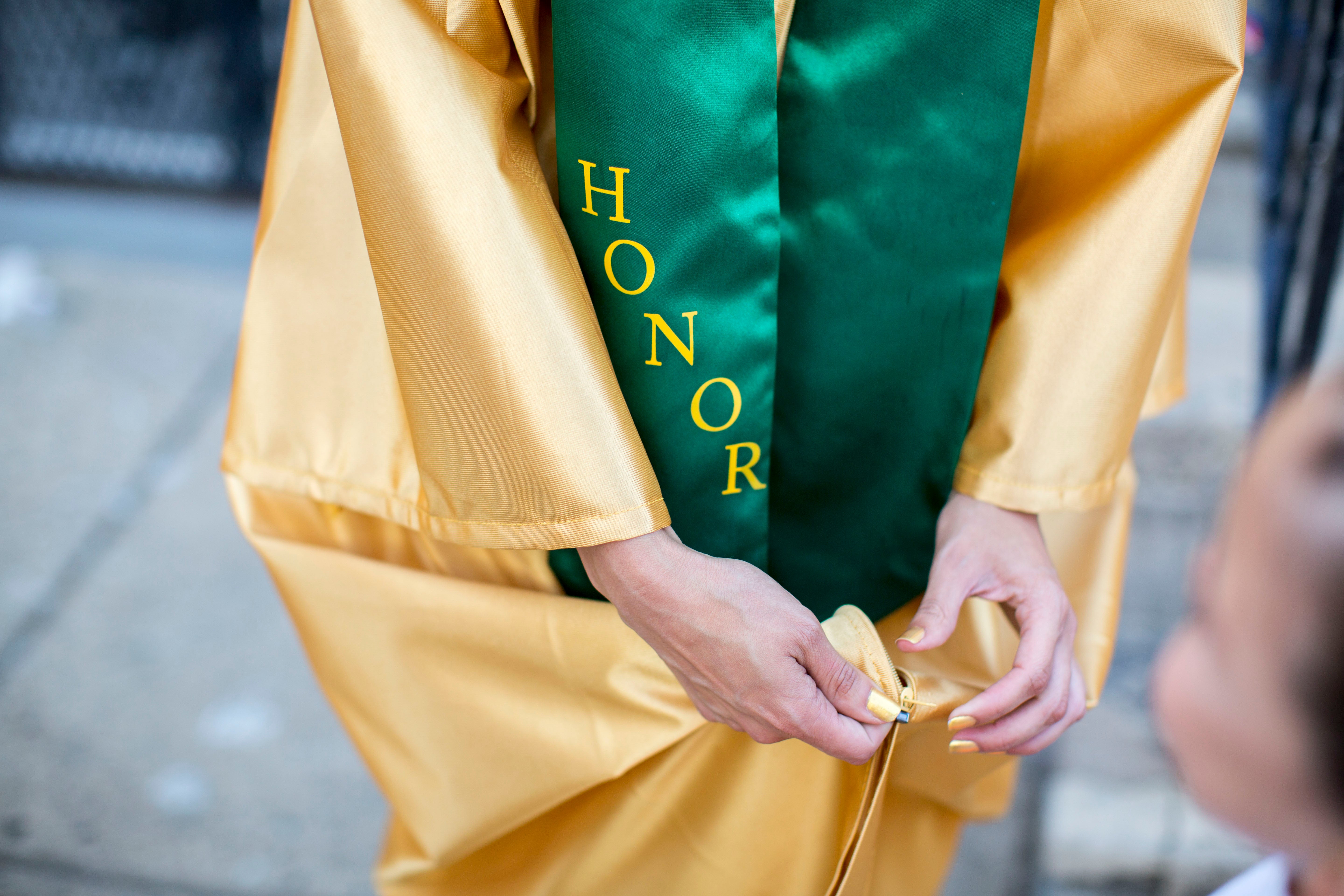 Savannah finished her senior year with a cumulative GPA that ranked her in the top 25 of her class, a designation that earned her a special gold gown and green sash. (Jessica Kourkounis/For Keystone Crossroads)