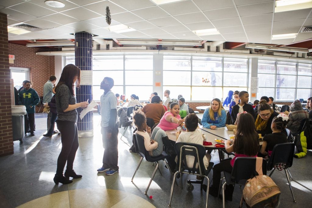 Children eat a snack during Providence’s after school program in the cafeteria of Julia de Burgos Elementary. (Jessica Kourkounis/For Keystone Crossroads)