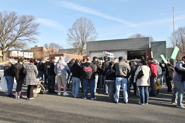 <p>Members of Local 22 and supporters gather outside the ribbon cutting of Engine 38 to protest the brownouts at other stations and actions of Phila. Mayor Michael Nutter. (Kimberly Paynter/WHYY)</p>
