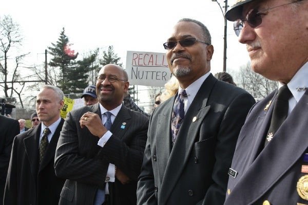 <p>Philadelphia Mayor Michael Nutter looks onto the dedication ceremony of Engine 38 in Tacony while Local 22 protesters shout for his recall. (Kimberly Paynter/WHYY)</p>
