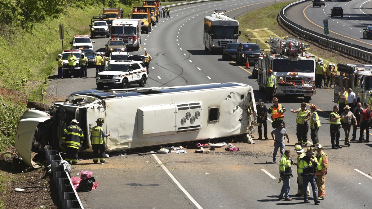  Emergency workers tend to an overturned bus on I-95 southbound, Monday in Havre de Grace, Maryland. Cpl. Tyler Allaband of the Maryland State Police said by telephone that the bus overturned in the southbound lanes of the highway on Monday near the exit for Havre de Grace.  (Amy Davis/The Baltimore Sun via AP)  