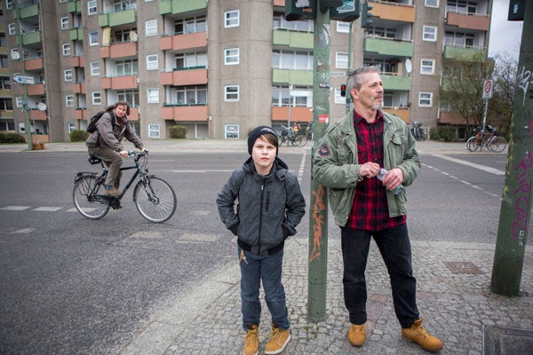Andreas Rissmann (right), a single father, walks with his son Lysander in the Wedding section of Berlin, Germany. (Jessica Kourkounis/For Keystone Crossroads)