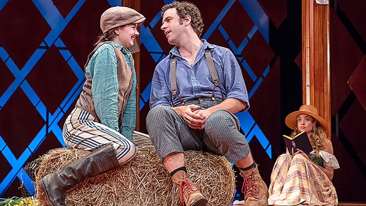  In disguise, Rosalind (Marnie Schulenburg) woos Orlando (Zack Robidas) as Celia(Stella Baker) looks on in Pennsylvania Shakespeare Festival’s production of 'AsYou Like It.' (Photo courtesy of Lee A. Butz)  