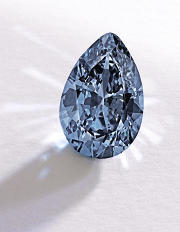 In this image provided by Sotheby’s shows a Fancy Vivid Blue pear-shaped diamond from the estate of Rachel 