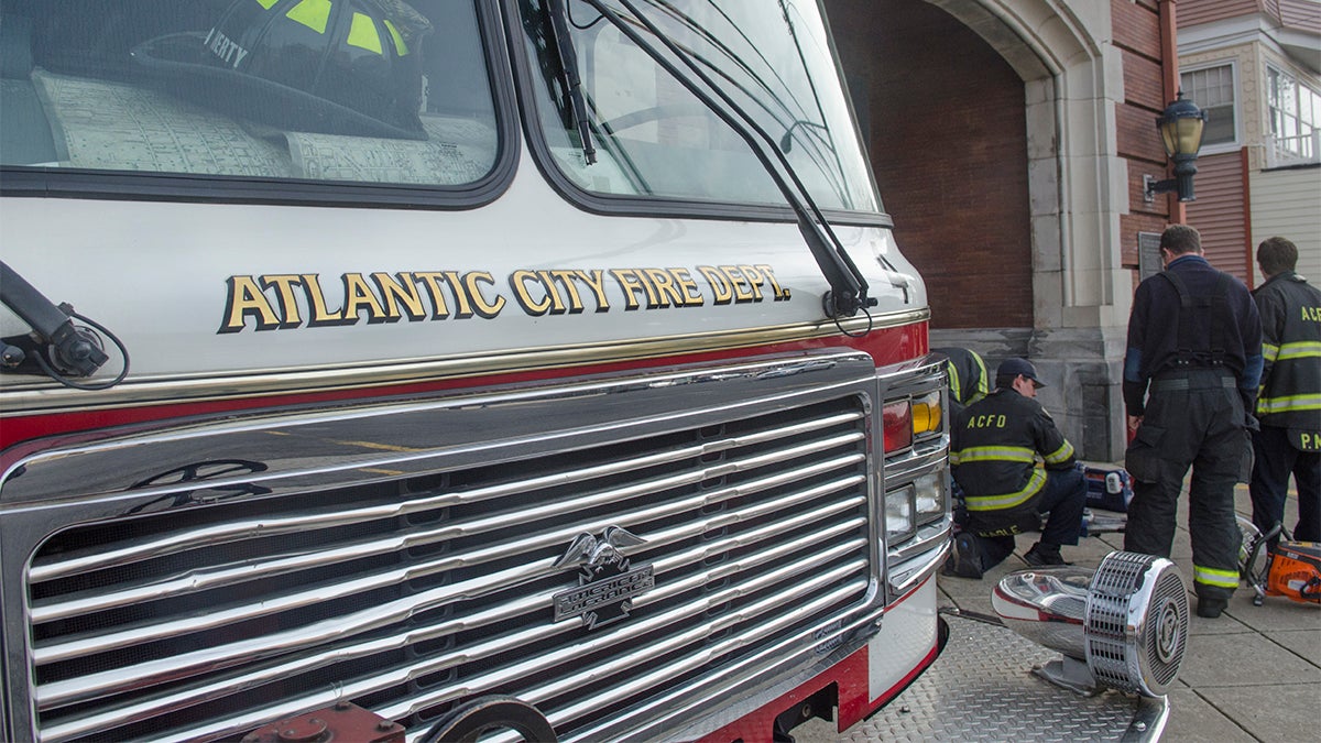  Atlantic City firefighters from Station 4,  Engine 4, Ladder 2, California Ave. prepare for duty. (Anthony Smedile for NewsWorks) 