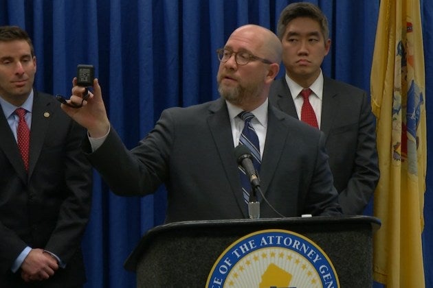  New Jersey Attorney General Chris Porrino showing one of the cameras the office lends out to those wishing to keep tabs on those caring for elderly relatives (New Jersey Department of Consumer Affairs) 