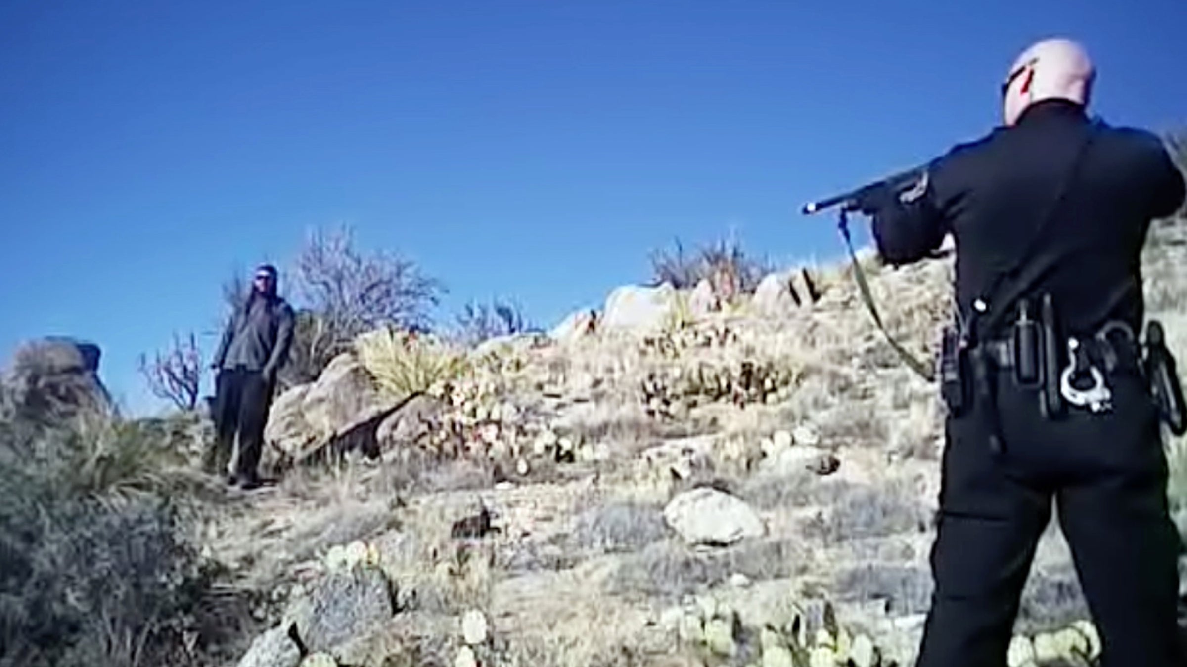  This image made from a March 16, 2014, video shows James Boyd, 38, left, during a standoff with officers in the Sandia foothills in Albuquerque, N.M., before police fatally shot him. The shooting of Boyd, who suffered from mental illness, ended a nearly five-hour standoff that involved more than a dozen officers by the time it ended. (Albuquerque Police Department via AP, File ) 