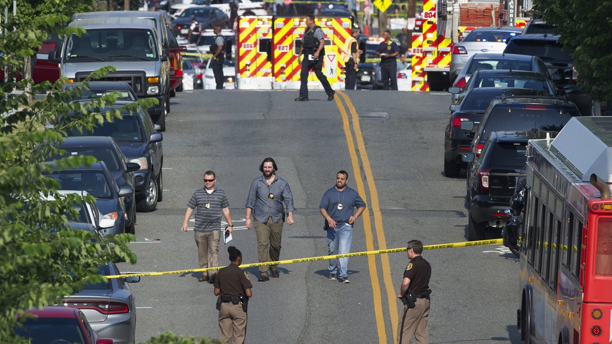 Police and emergency personnel are seen near the scene where House Majority Whip Steve Scalise of Louisiana was shot during a Congressional baseball practice in Alexandria, Va., Wednesday, June 14, 2017.  (AP Photo/Cliff Owen, file) 